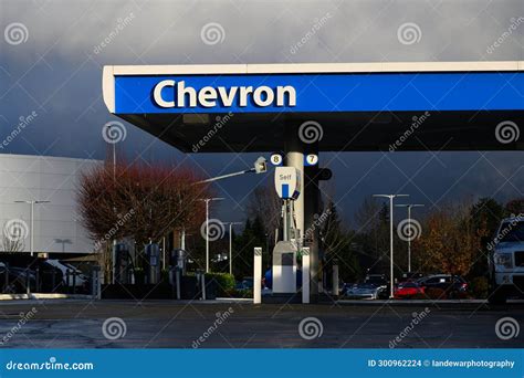 Chevron Sign On Gas Station Awning In Blue And White In Wet Weather