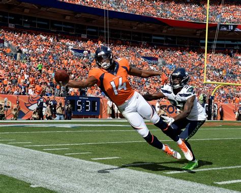 Download Courtland Sutton Catching Football During Game Wallpaper