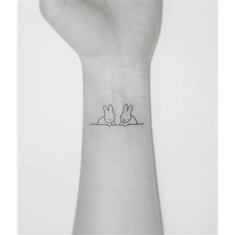 Fine Line Rabbit Tattoo Located On The Wrist