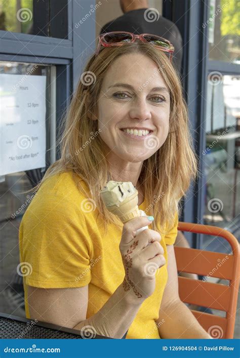 Forty Five Year Old Woman Enjoying And Ice Cream Cone On Family