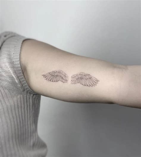 Micro Realistic Wings Tattoo On The Inner Arm