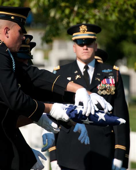 Soldiers In The 3D Us Infantry Regiment The Old Guard Hold A Perfectly Folded Flag Over