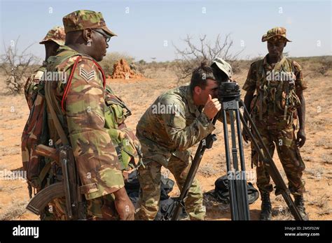 U S Army Spc Dylan Stratton Middle Technical Engineer With The Headquarters And Headquarters Company 54Th Brigade Engineer Battalion 173Rd Airborne Brigade Double Checks A Surveying Instrument For Kenyan Defence Forces Soldiers March
