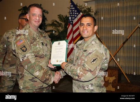 U S Army Staff Sgt Orlando Alvarez Right A Parachute Rigger Assigned To The Group Support Battalion 7Th Special Forces Group Airborne Receives An Award From Lt Col Daniel A Lancaster Left Group