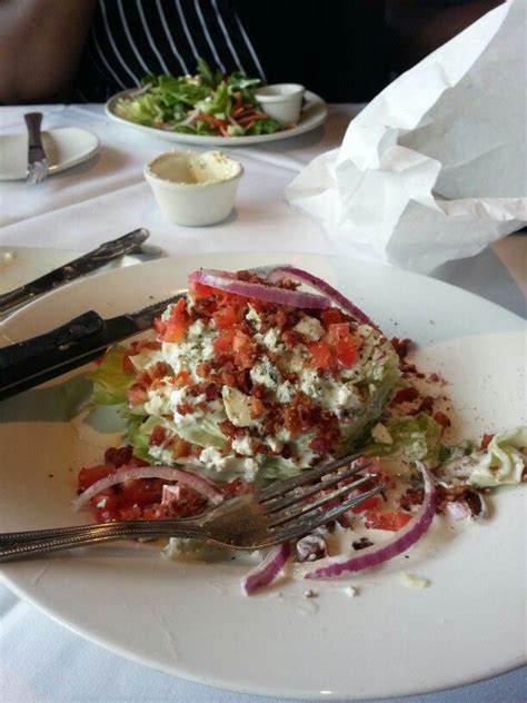 Wedge Of Lettuce Tomatoes Bacon Bits Red Onions Blue Cheese Crumbs